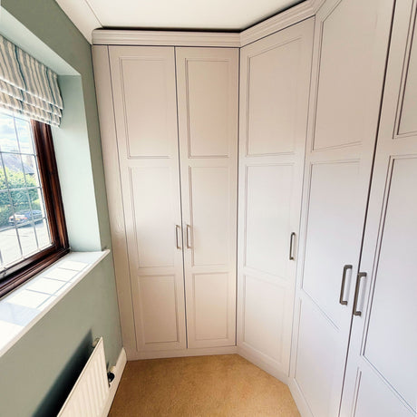 Bedroom renovation showing fitted wardrobes wrapping around an angled corner