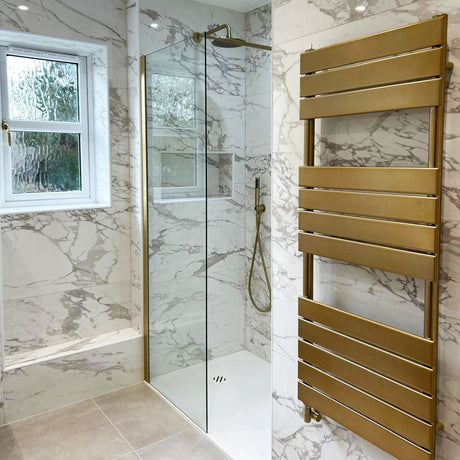 Walk-in wetroom shower with marble-effect tiled walls and a brushed brass heated towel rail, Hartwell bathroom renovation